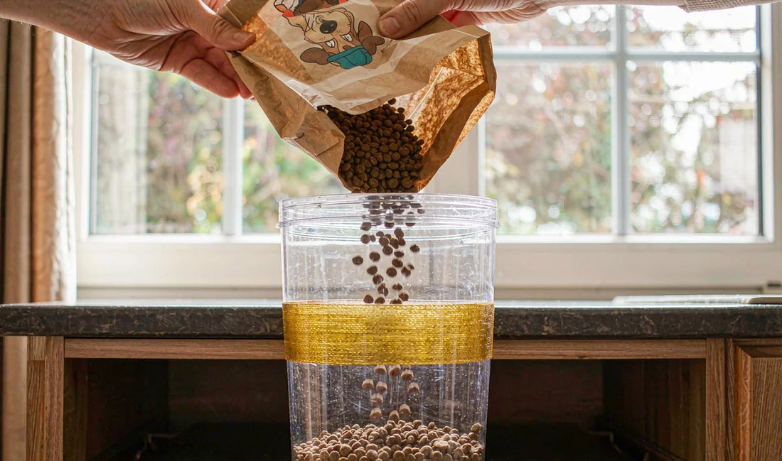 Hands pouring kibble from a bag into a storage container