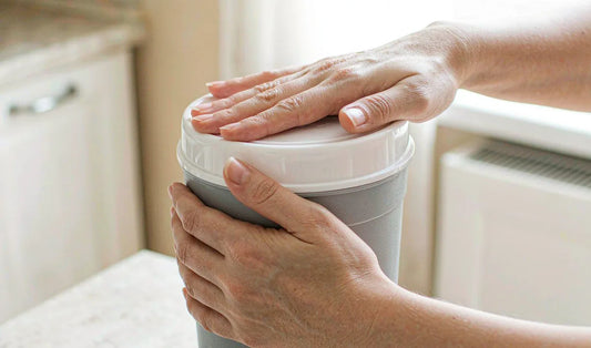 Hands sealing the lid on a pet food container